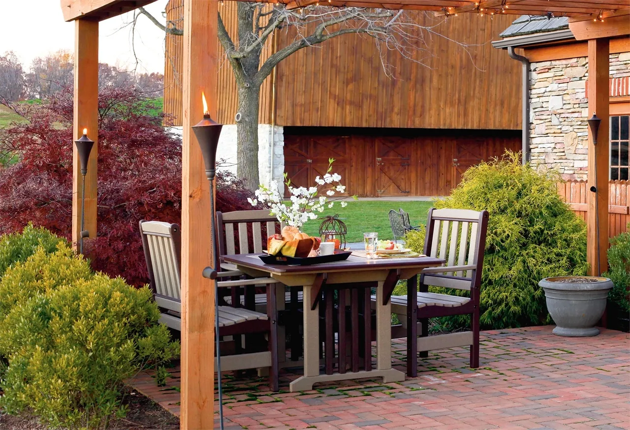 A table and chairs set up outside in the sun.