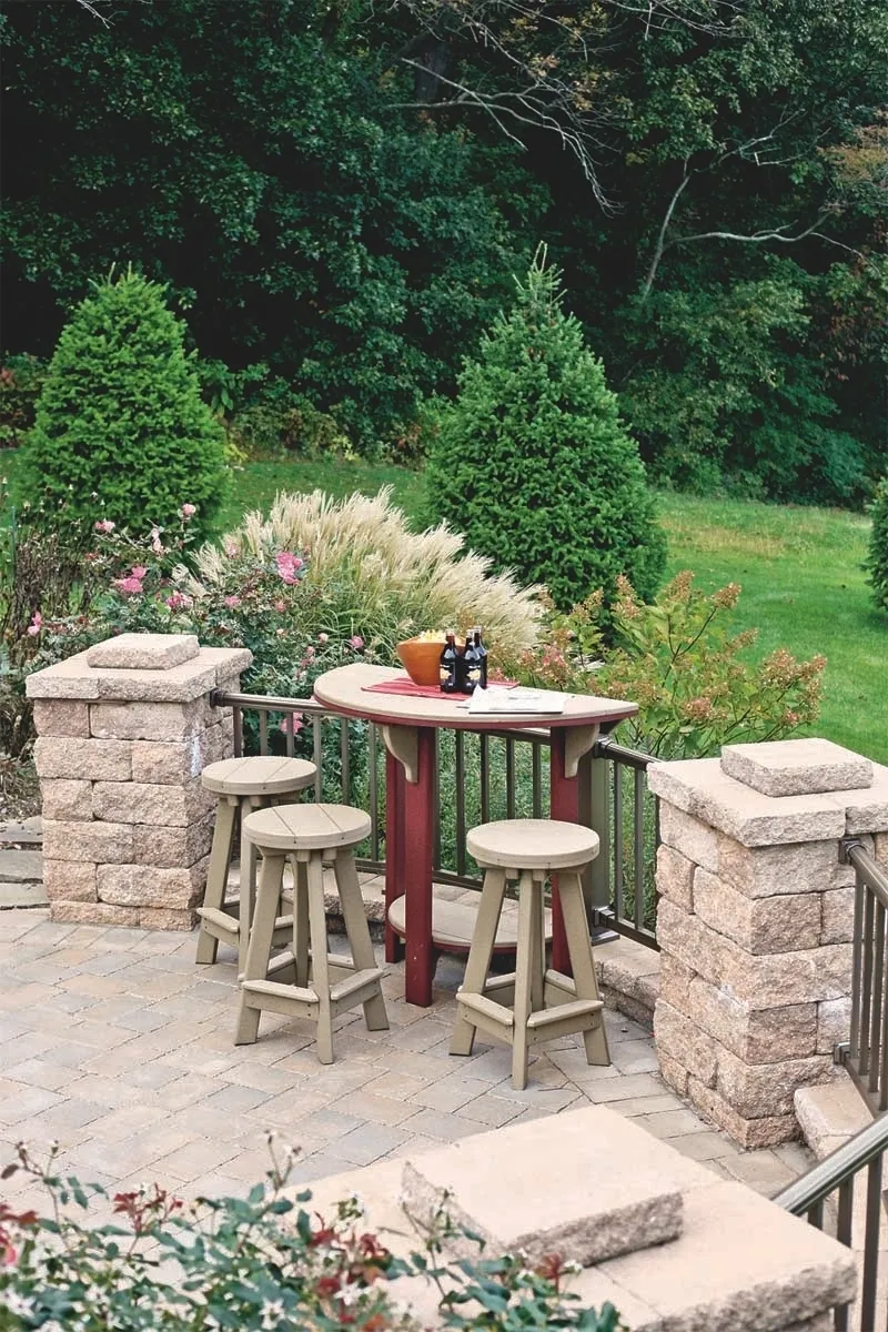 A patio with four stools and a table.