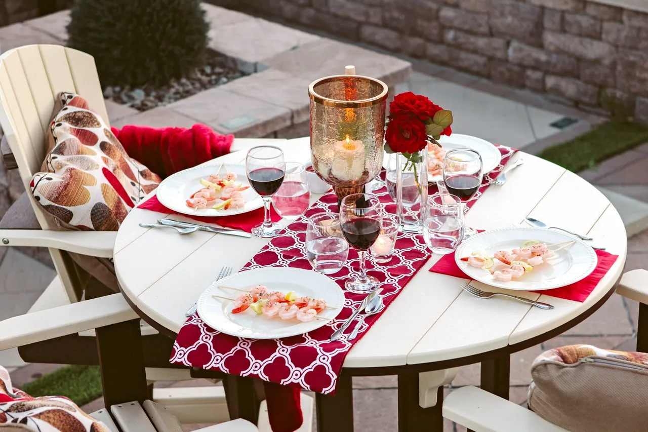 A table set with plates and wine glasses.