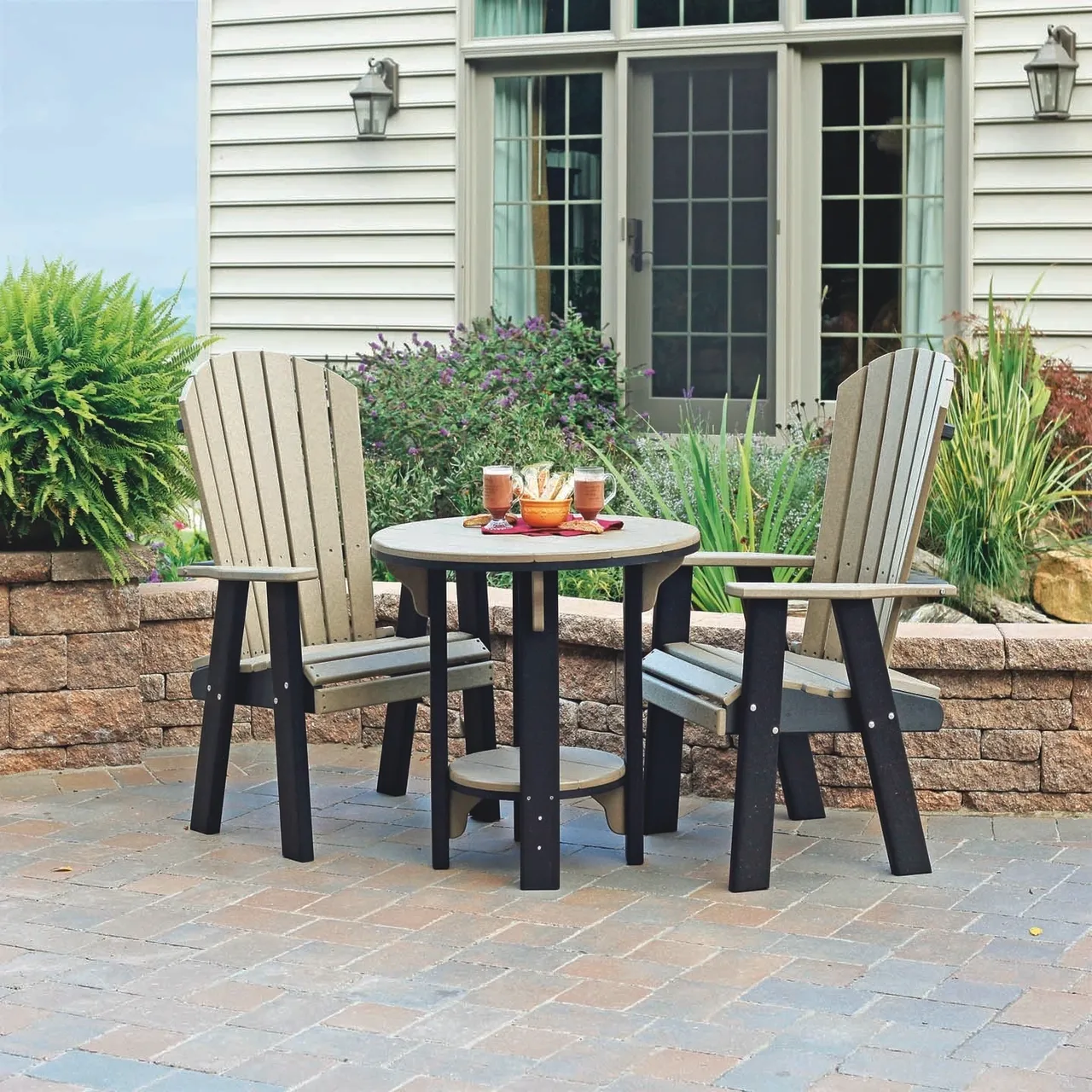 A table and two chairs sitting on top of a brick patio.