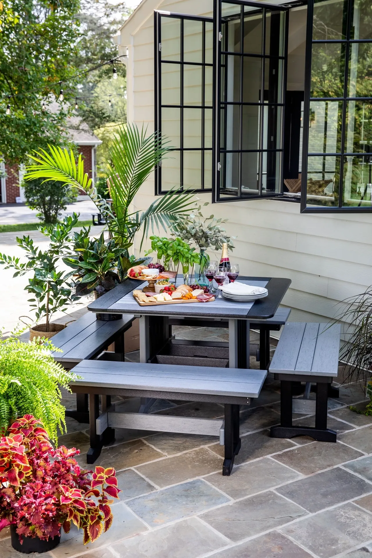 A table with two benches and plates of food on top.