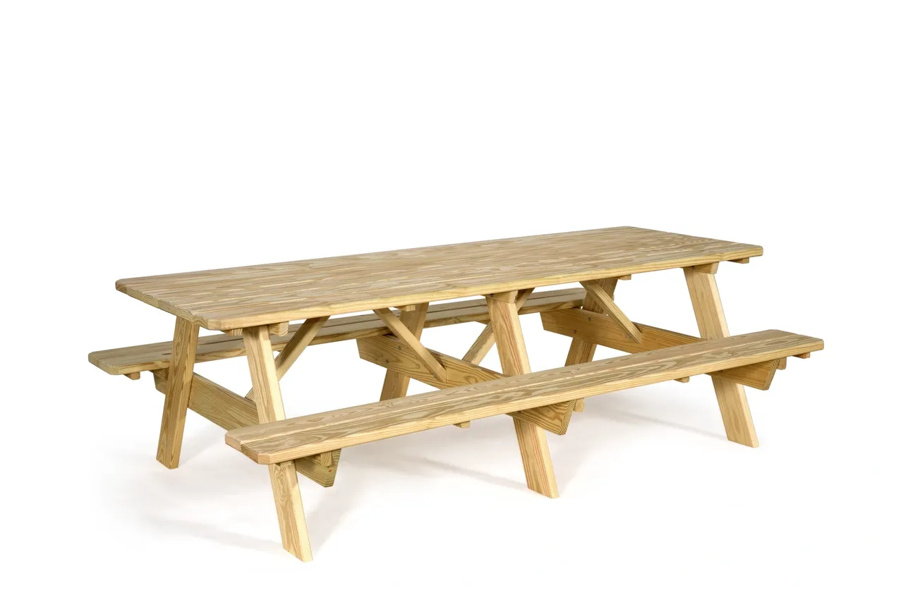 A wooden picnic table with benches on top of it.