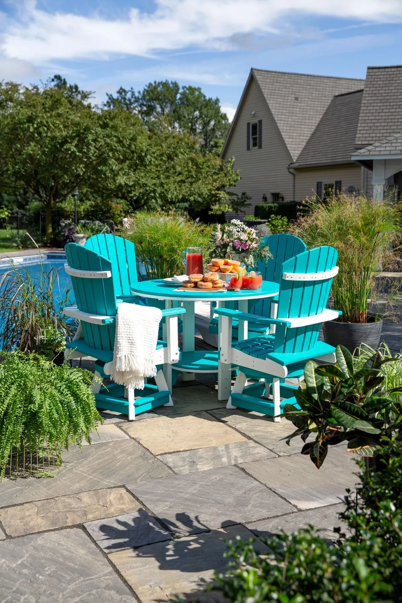 A table and chairs set up in the backyard.