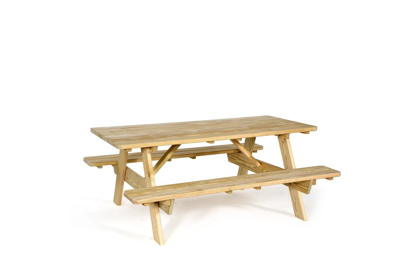 A wooden picnic table with benches on top of it.