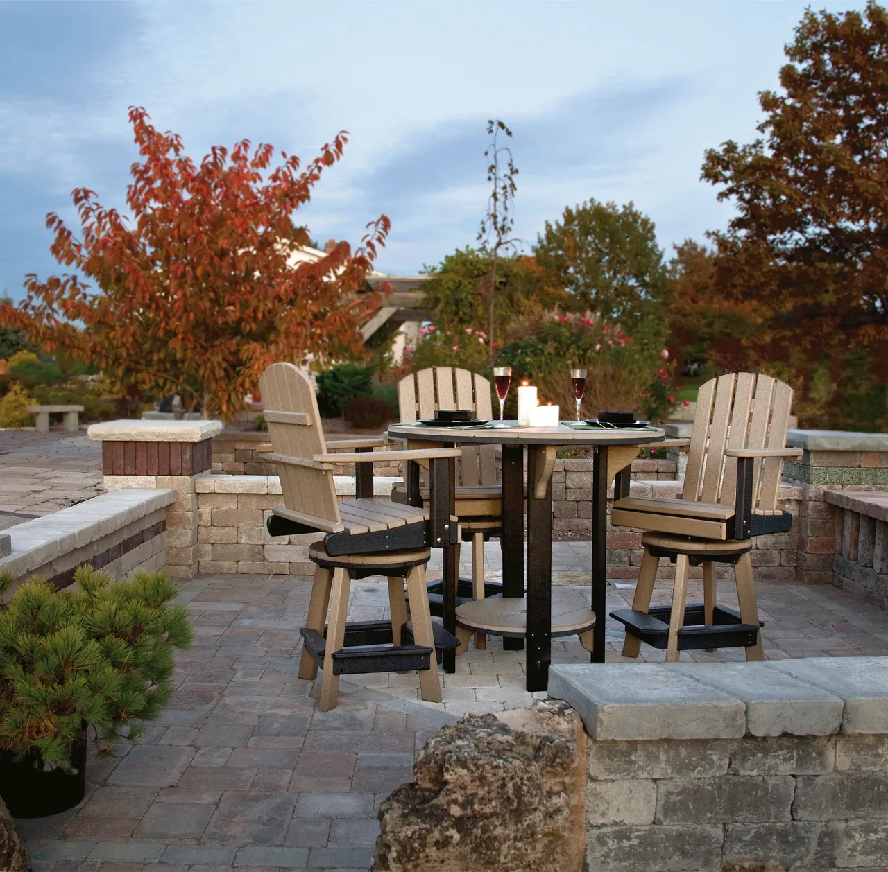 A patio with chairs and tables in the middle of it.