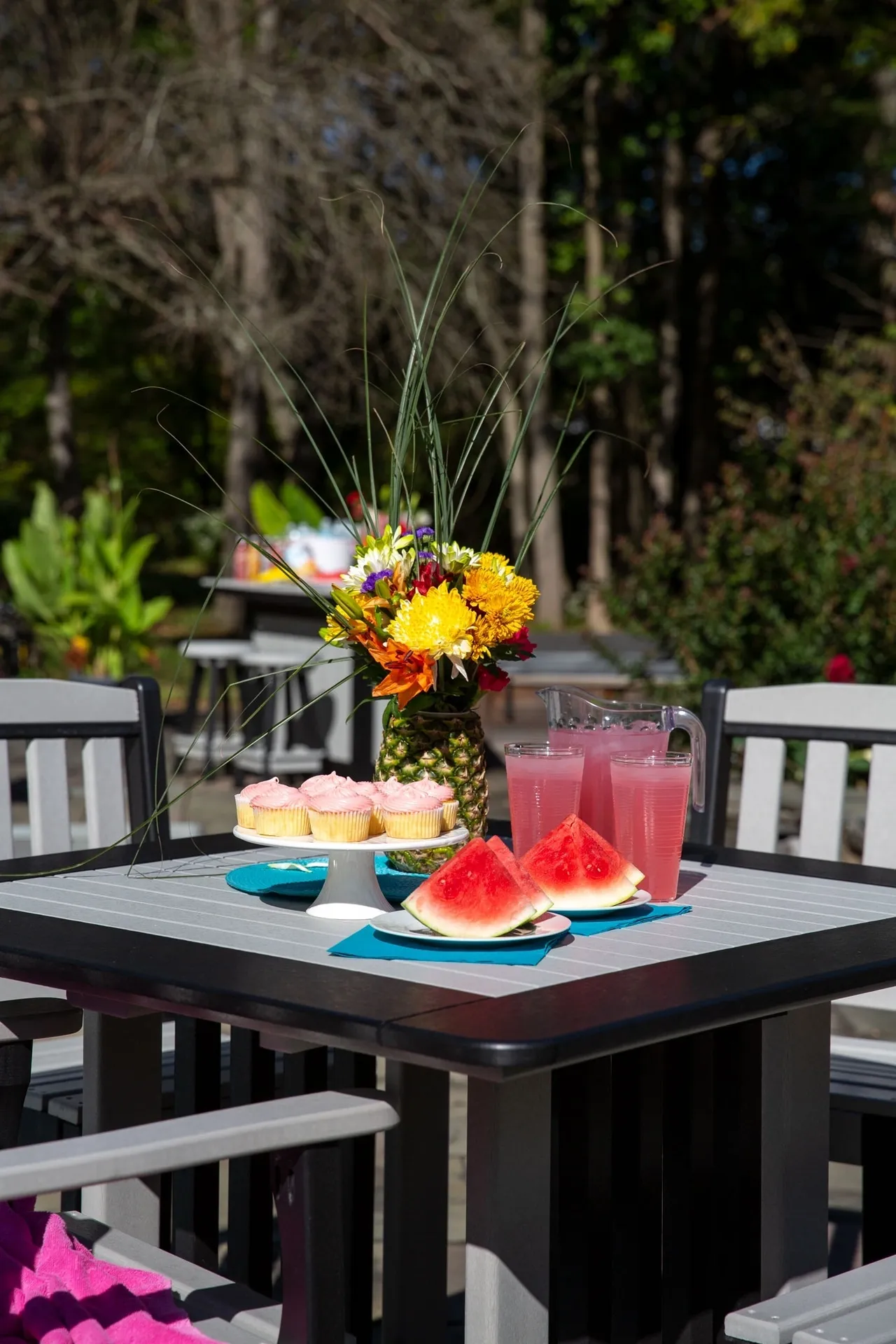 A table with watermelon and pineapple slices on it.