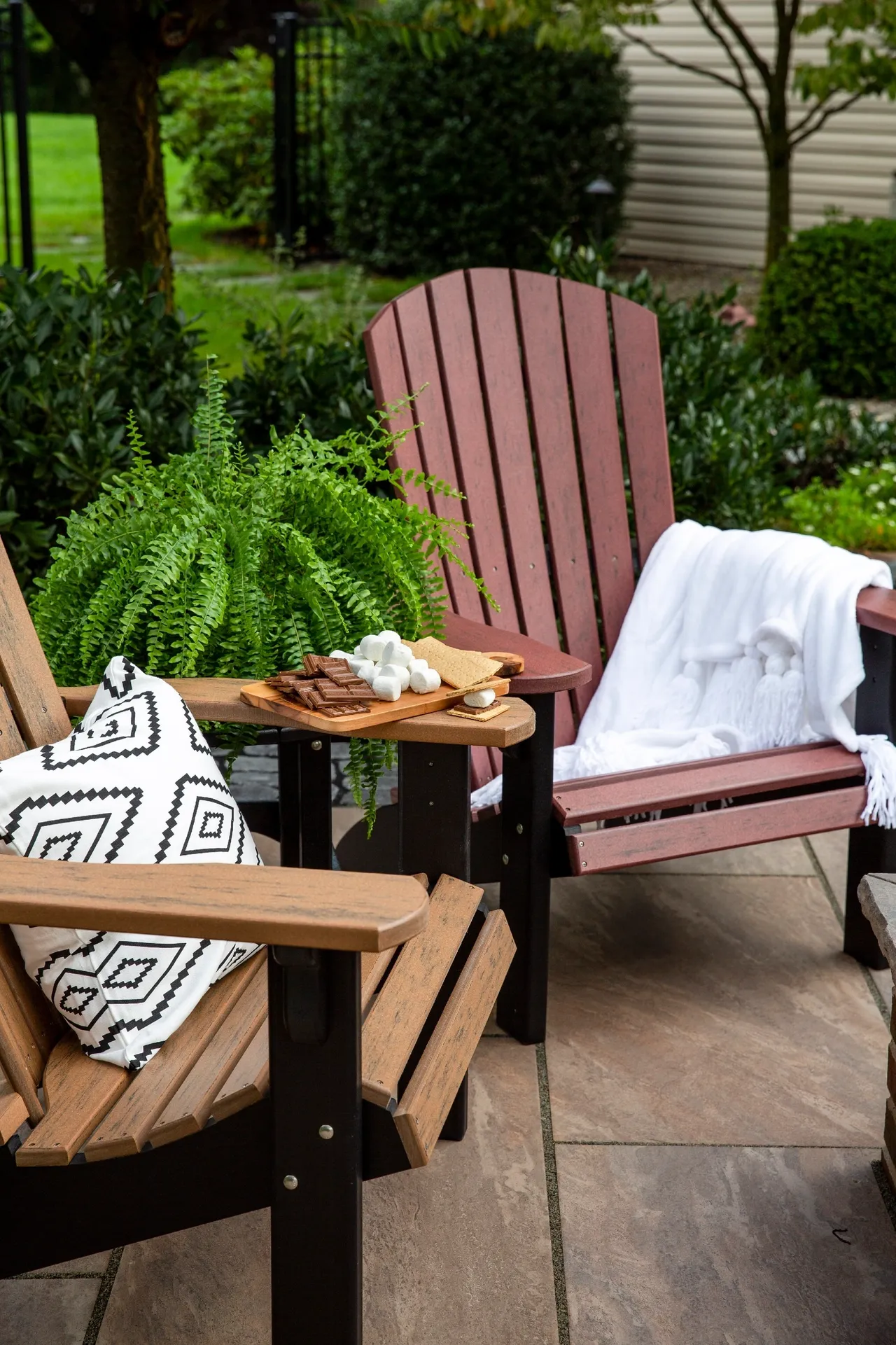 A couple of chairs and tables on top of a patio.