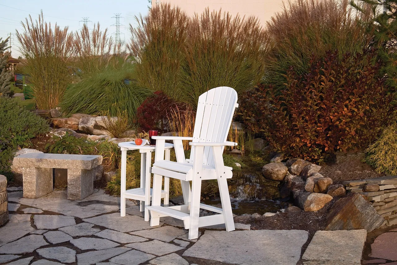 A white chair and table on the patio.