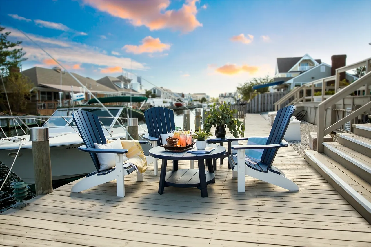 A deck with chairs and table on it
