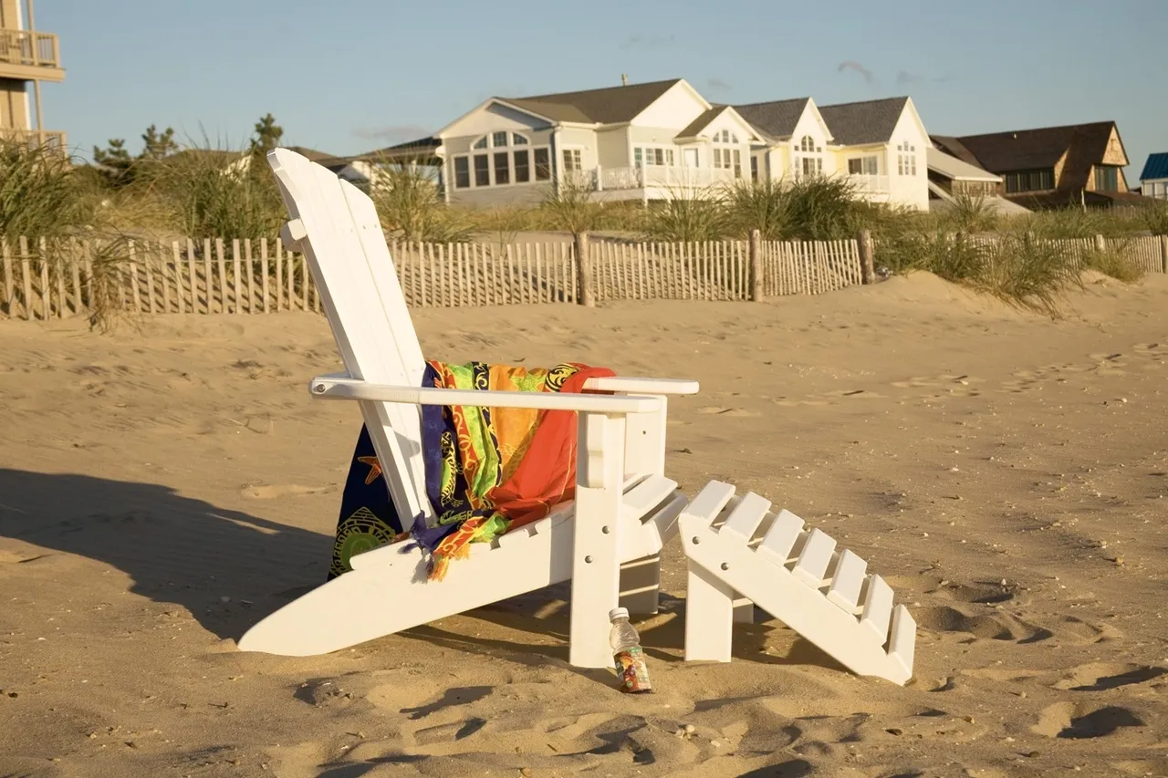 A beach chair with a towel on it