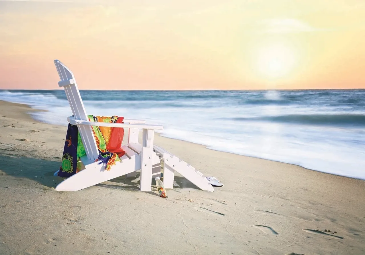 A beach chair with colorful towels on it