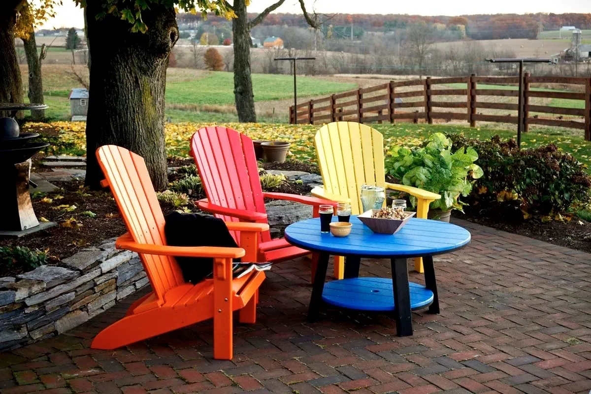 A table and chairs on the patio of an outdoor room.