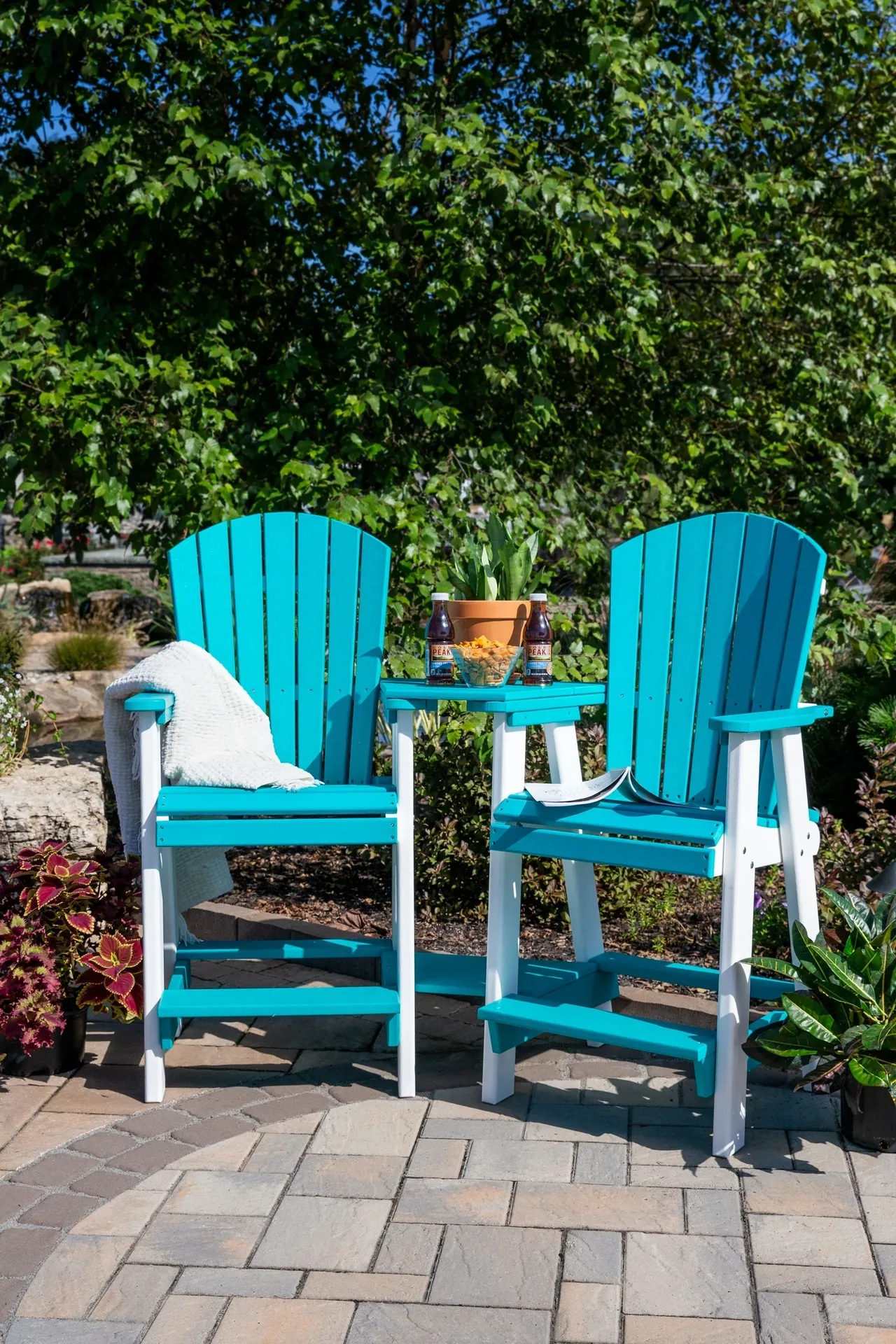 Two blue and white chairs sitting on a patio.