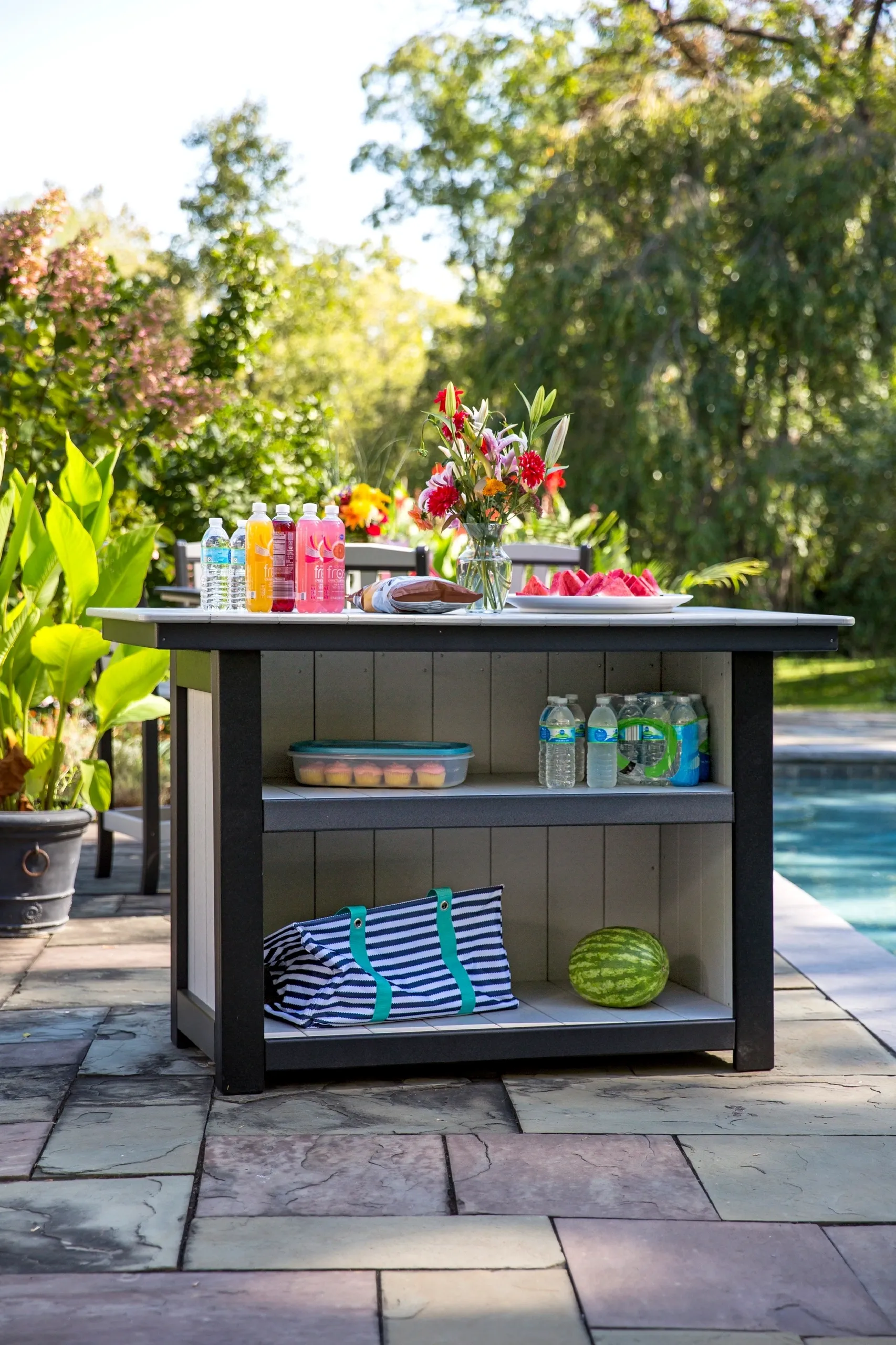 A table with two shelves and a drink holder.